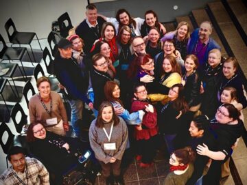 Group hug of musementoring participants and mentors